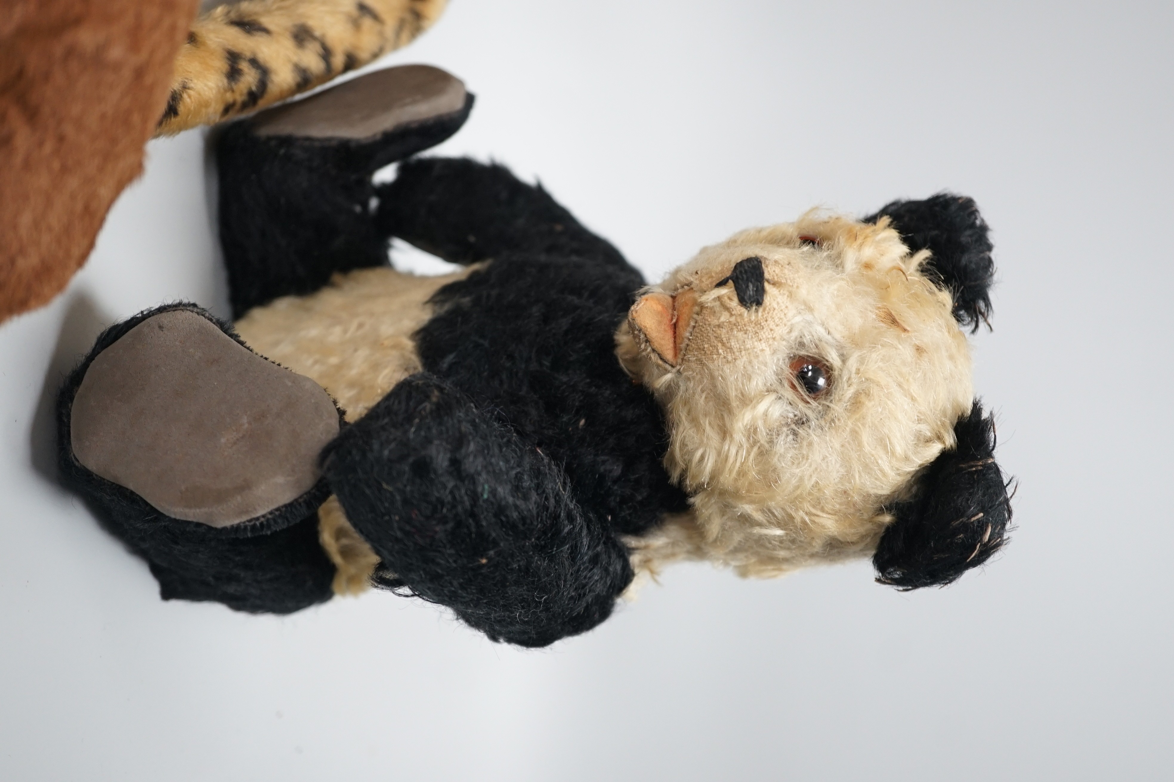 Three Steiff soft toys and a Japanese clockwork bear